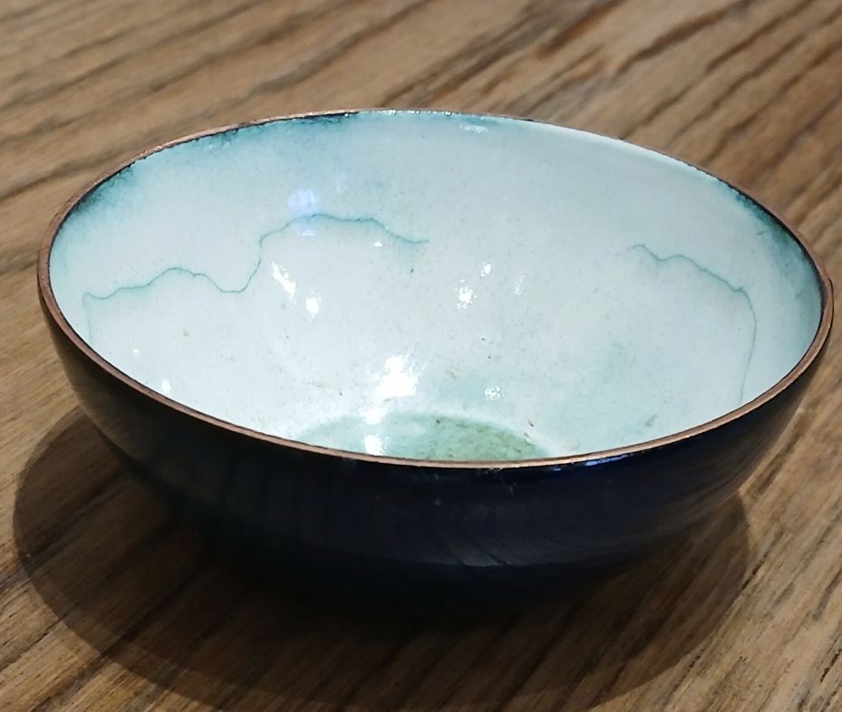 Blue enamelled bowl with a white cloud like interior